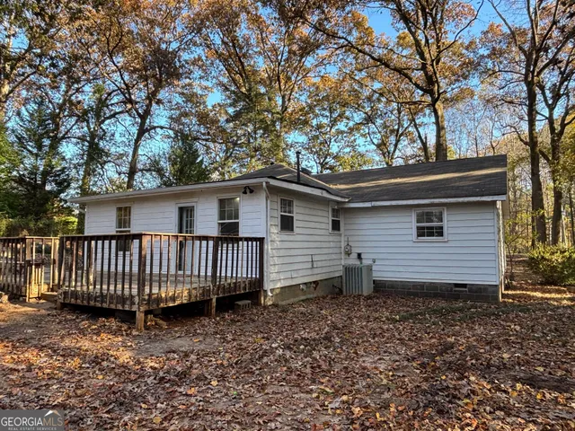 a view of a house with a yard and wooden fence
