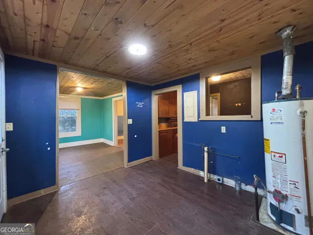 a view of a hallway with wooden cabinets and entryway