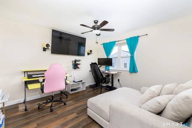a living room with furniture and a flat screen tv
