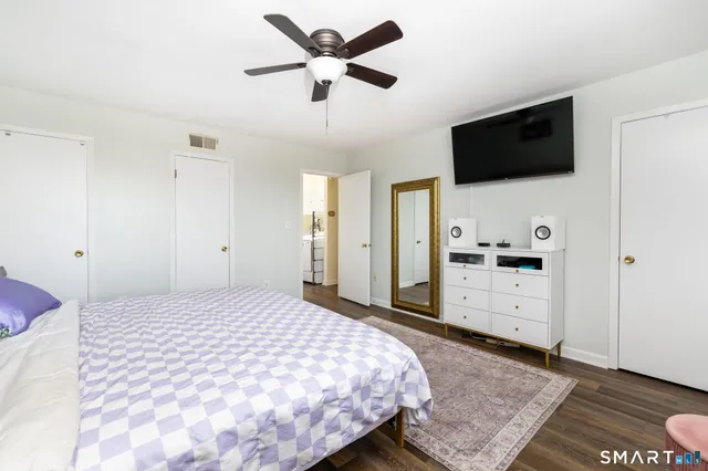 a bedroom with a bed and a flat screen tv