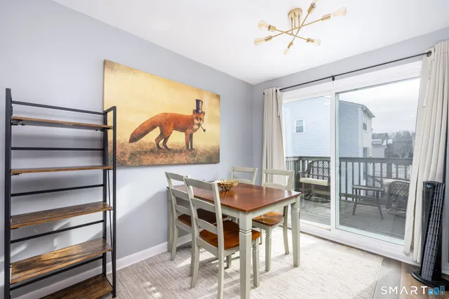 a dining room with furniture and a floor to ceiling window