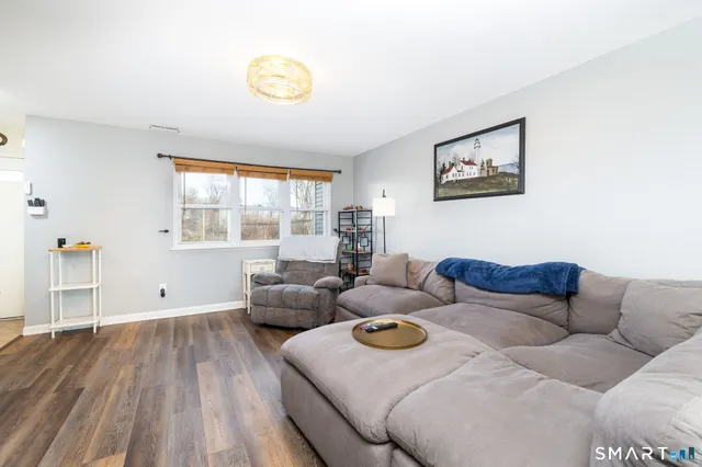 a living room with couches and a table with wooden floor