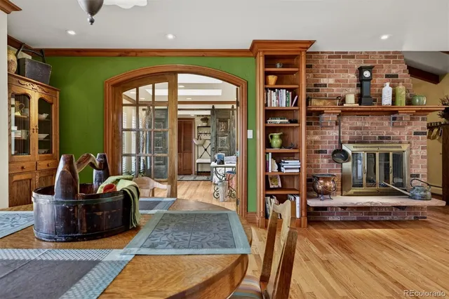 a living room with fireplace furniture and a rug