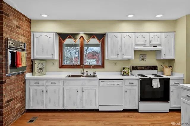 a kitchen with stainless steel appliances a sink and cabinets