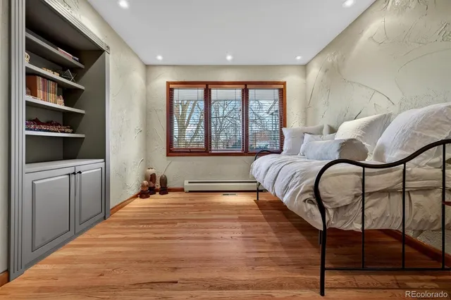 a bedroom with furniture and a window