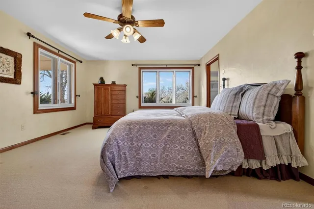 a spacious bedroom with a bed dresser and a window