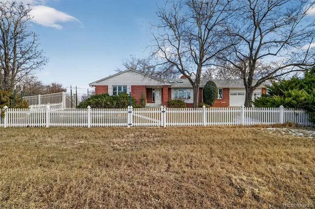 a view of a house with a backyard and a small yard