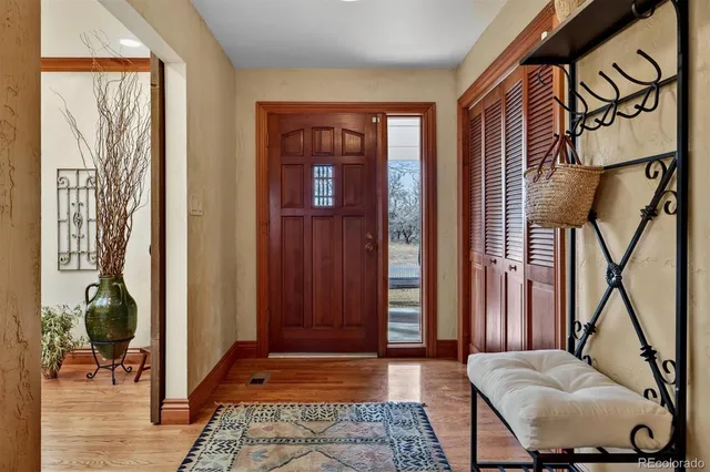 a view of front door with furniture and a window