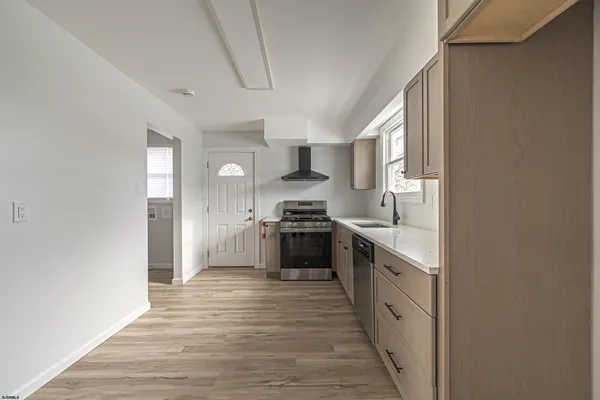 a kitchen with granite countertop a sink and steel appliances