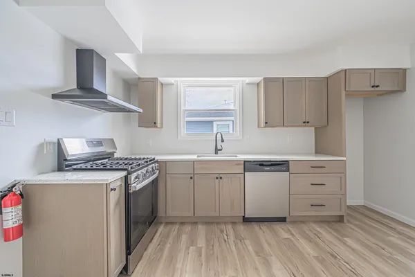 a kitchen with cabinets stainless steel appliances and a sink