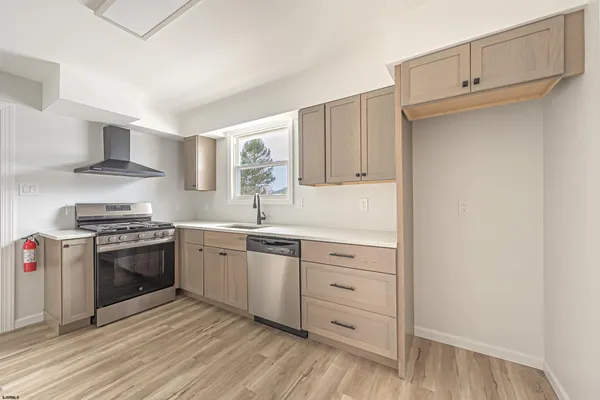 a kitchen with stainless steel appliances granite countertop a stove and a refrigerator
