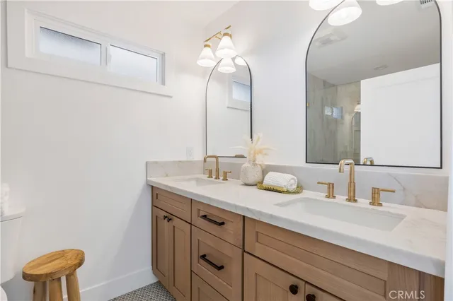 a bathroom with a double vanity sink and a mirror