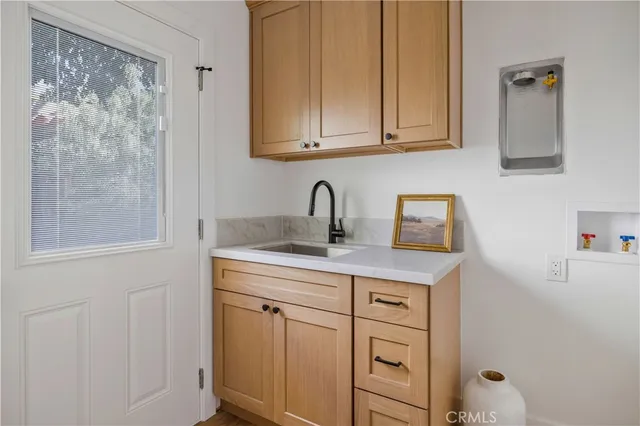 a view of a sink and cabinets