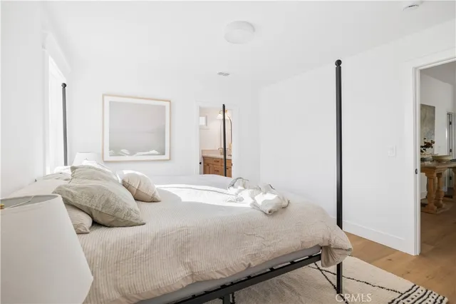 a bedroom with a bed and a large mirror in it