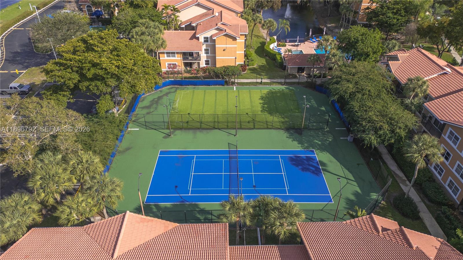 9033 Wiles Road, Unit 303 Coral Springs, FL 33067 - Photo 16 of 17 a view of brick house with a yard