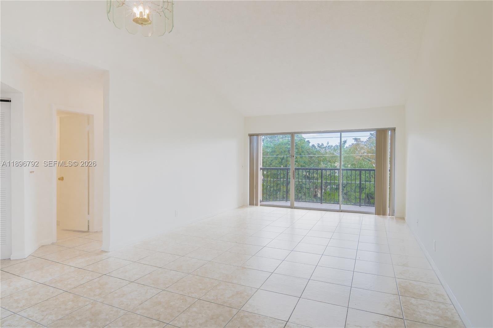 9033 Wiles Road, Unit 303 Coral Springs, FL 33067 - Photo 3 of 17 a view of an empty room with a window