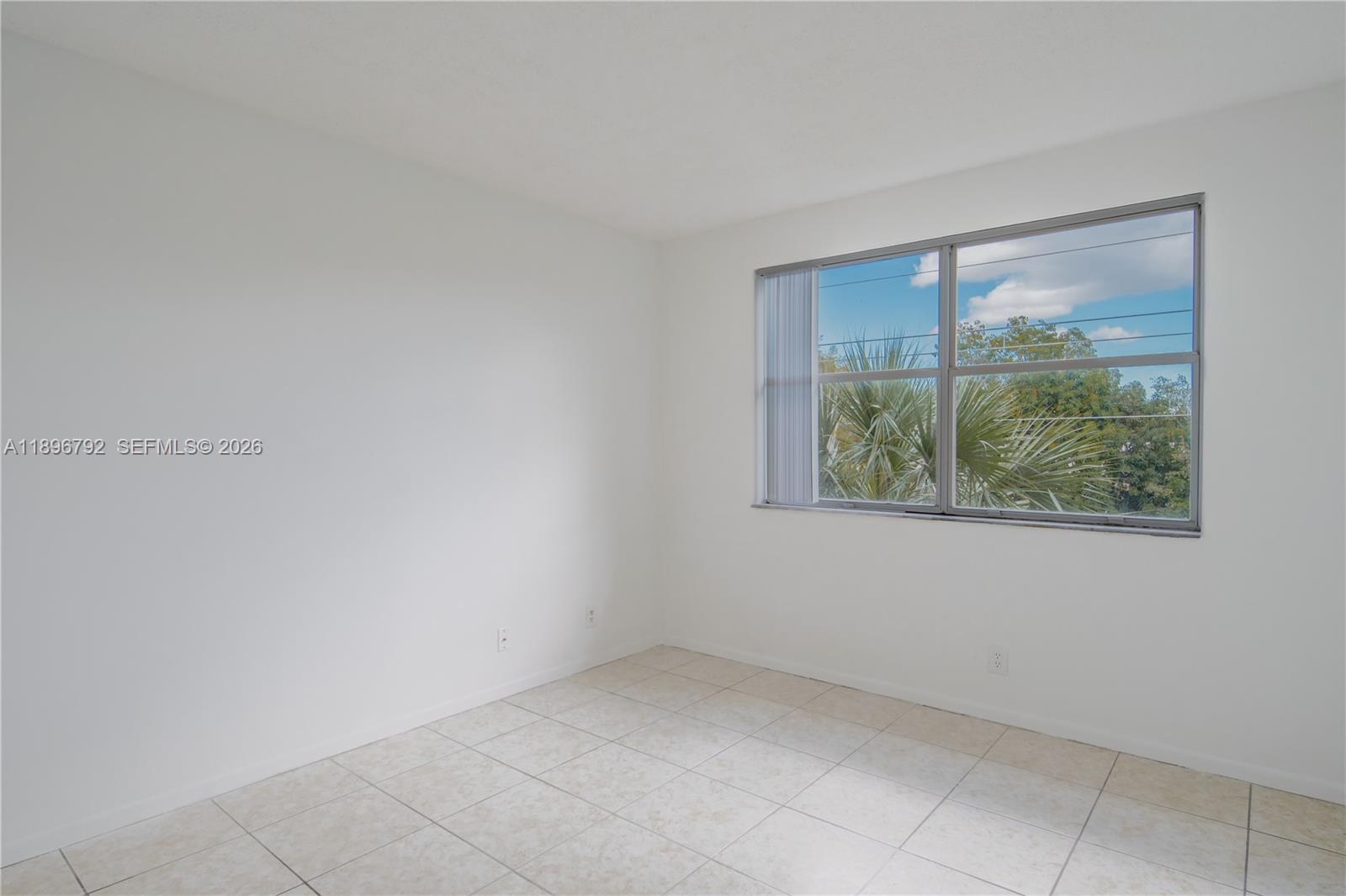 9033 Wiles Road, Unit 303 Coral Springs, FL 33067 - Photo 7 of 17 an empty room with a window