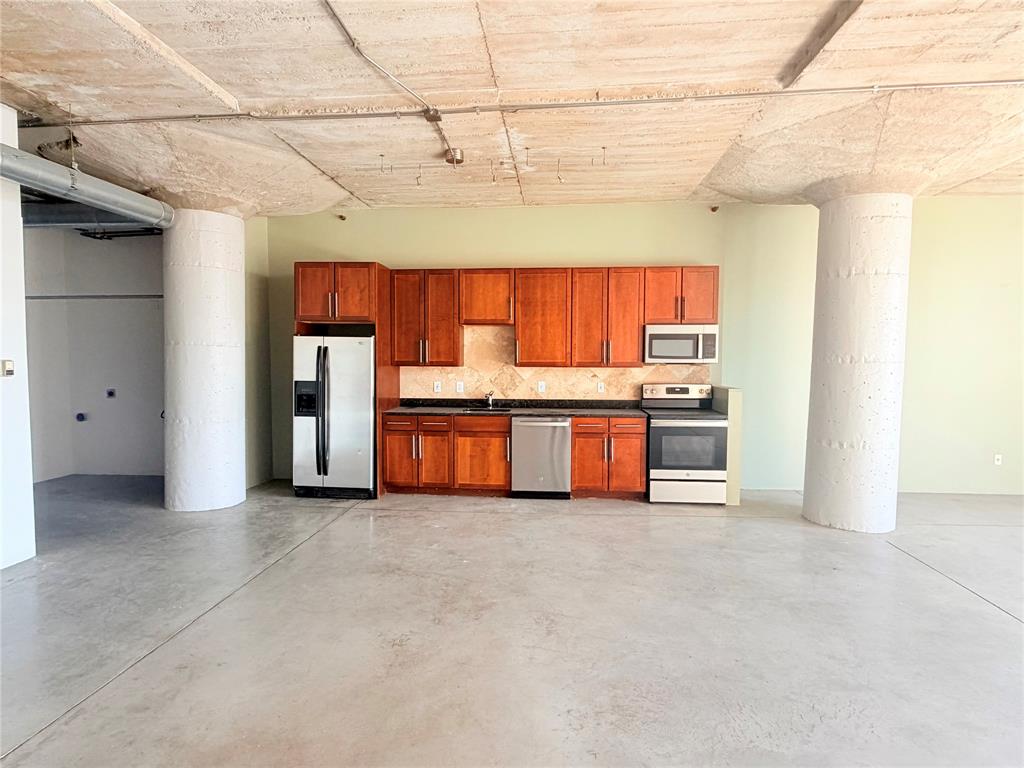 1122 Jackson Street, Unit 802 Dallas, TX 75202 - Photo 2 of 8 a view of kitchen with stainless steel appliances granite countertop lots of counter top space and cabinets