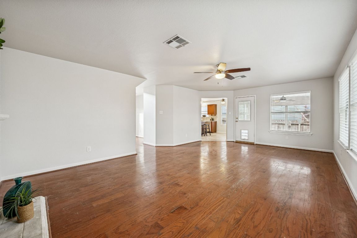 8611 Devine Lane Austin, TX 78748 - Photo 11 of 33 a view of an empty room with a window and wooden floor