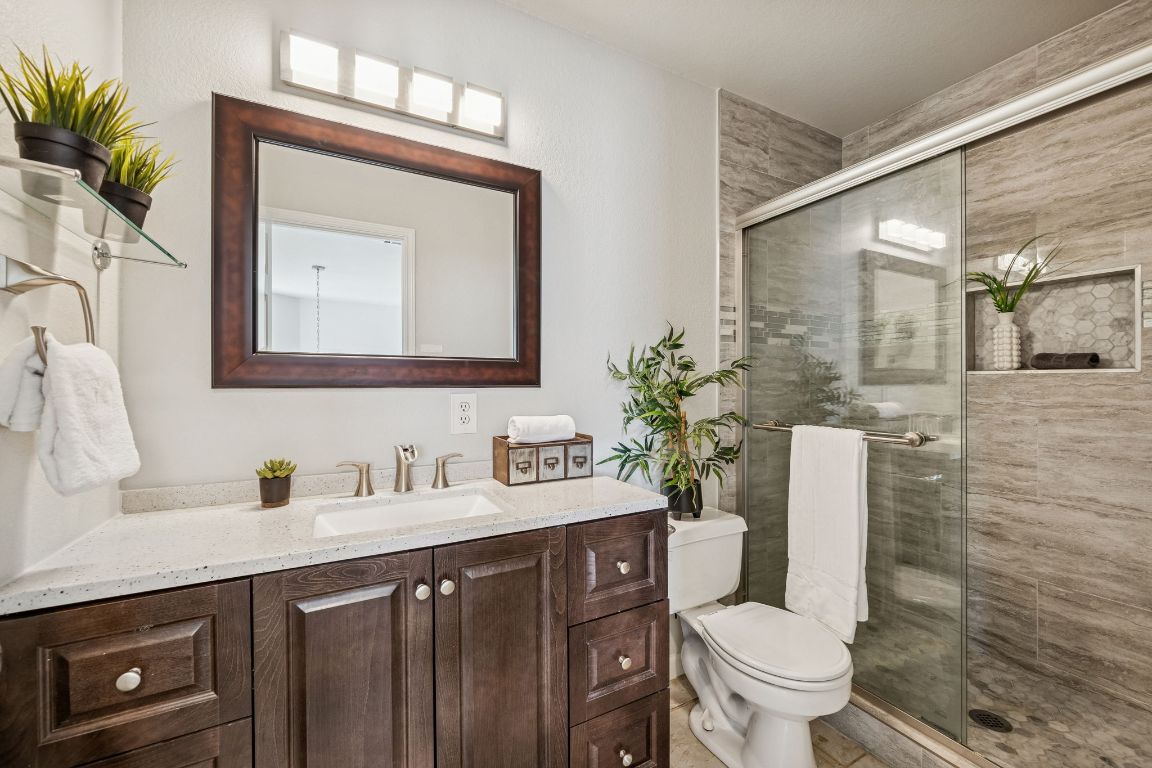 8611 Devine Lane Austin, TX 78748 - Photo 22 of 33 a bathroom with a toilet sink and mirror