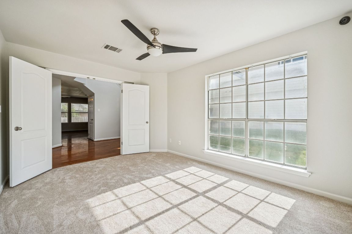 8611 Devine Lane Austin, TX 78748 - Photo 6 of 33 a view of empty room with wooden floor and fan