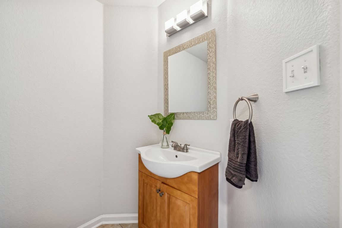 8611 Devine Lane Austin, TX 78748 - Photo 7 of 33 a bathroom with a sink vanity and a mirror