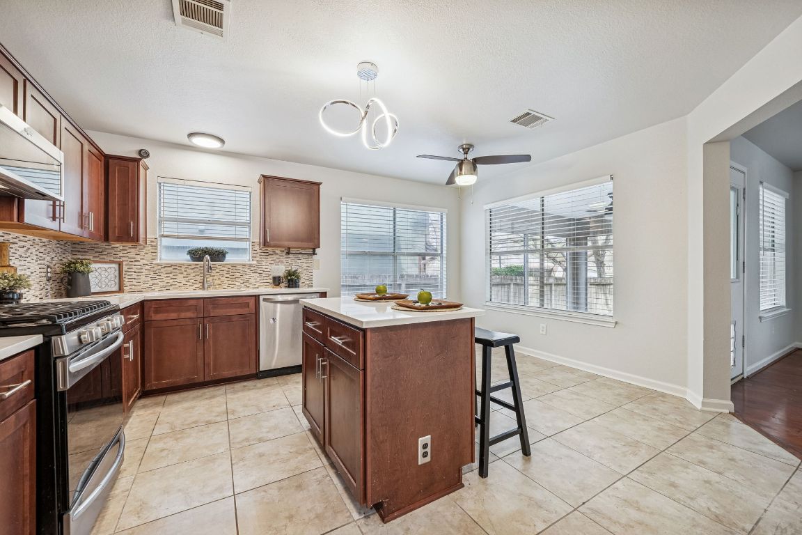 8611 Devine Lane Austin, TX 78748 - Photo 8 of 33 a kitchen with a stove sink and cabinets