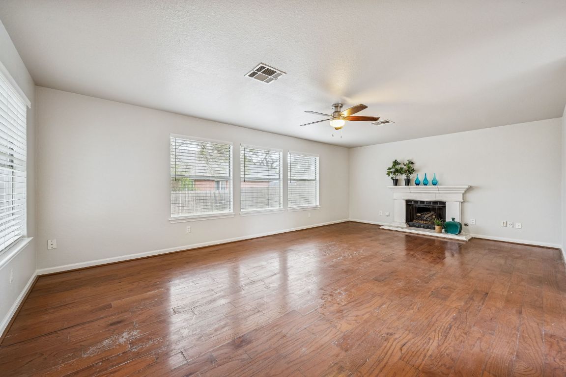 8611 Devine Lane Austin, TX 78748 - Photo 10 of 33 an empty room with windows and fireplace
