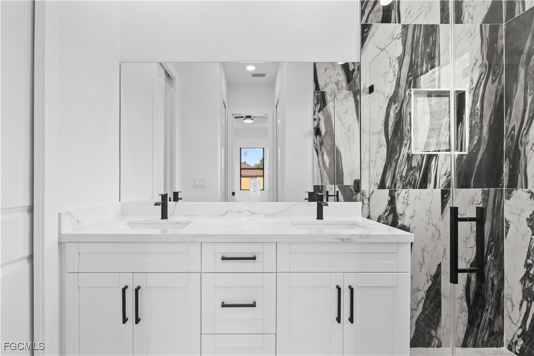 4006 5th Street Southwest Lehigh Acres, FL 33976 - Photo 16 of 32 a bathroom with double vanity sink and a mirror