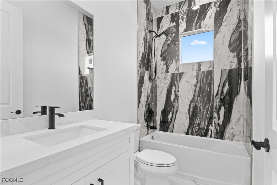 4006 5th Street Southwest Lehigh Acres, FL 33976 - Photo 17 of 32 a bathroom with a sink toilet and shower