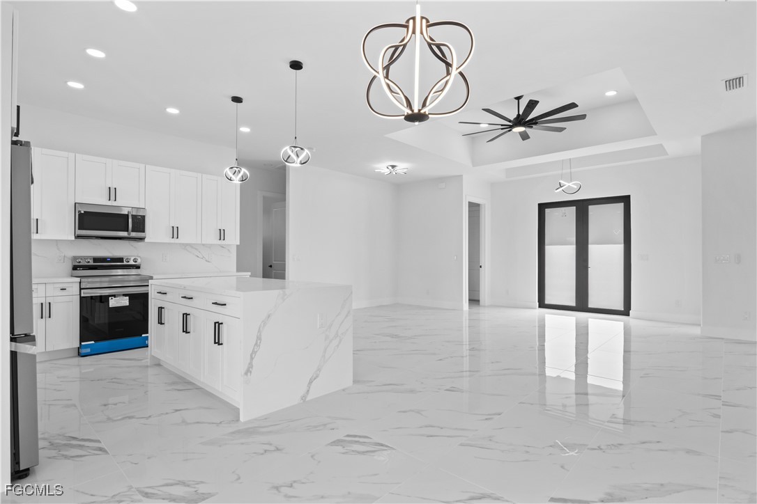 4006 5th Street Southwest Lehigh Acres, FL 33976 - Photo 18 of 32 a large white kitchen with cabinets