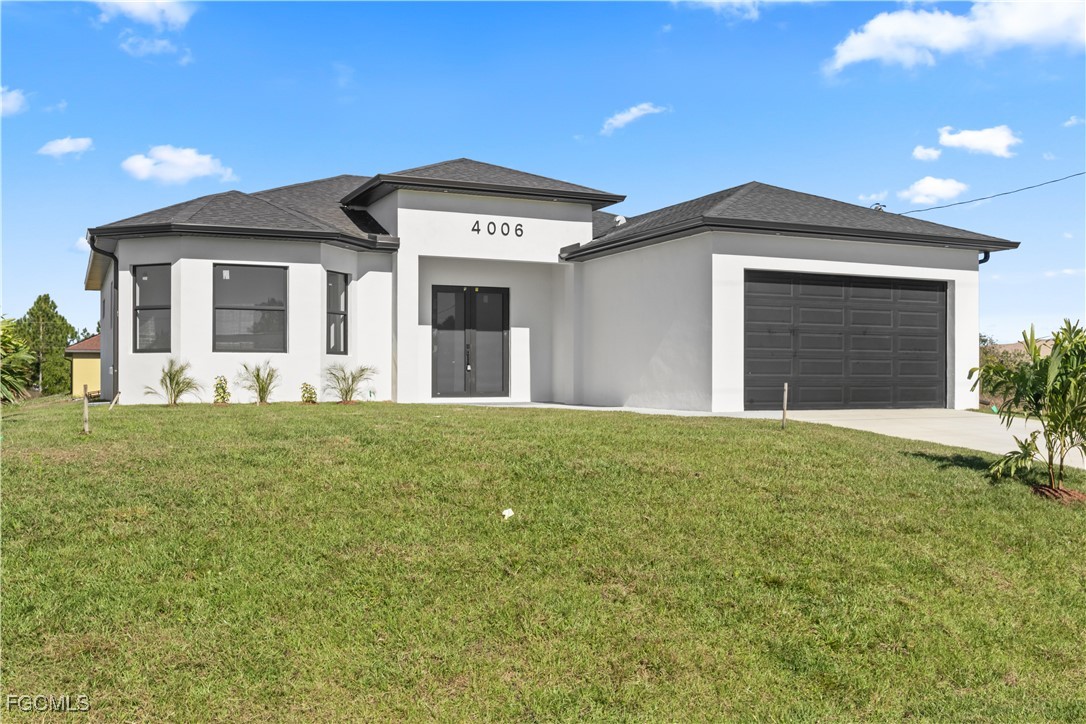 4006 5th Street Southwest Lehigh Acres, FL 33976 - Photo 2 of 32 a front view of a house with a yard