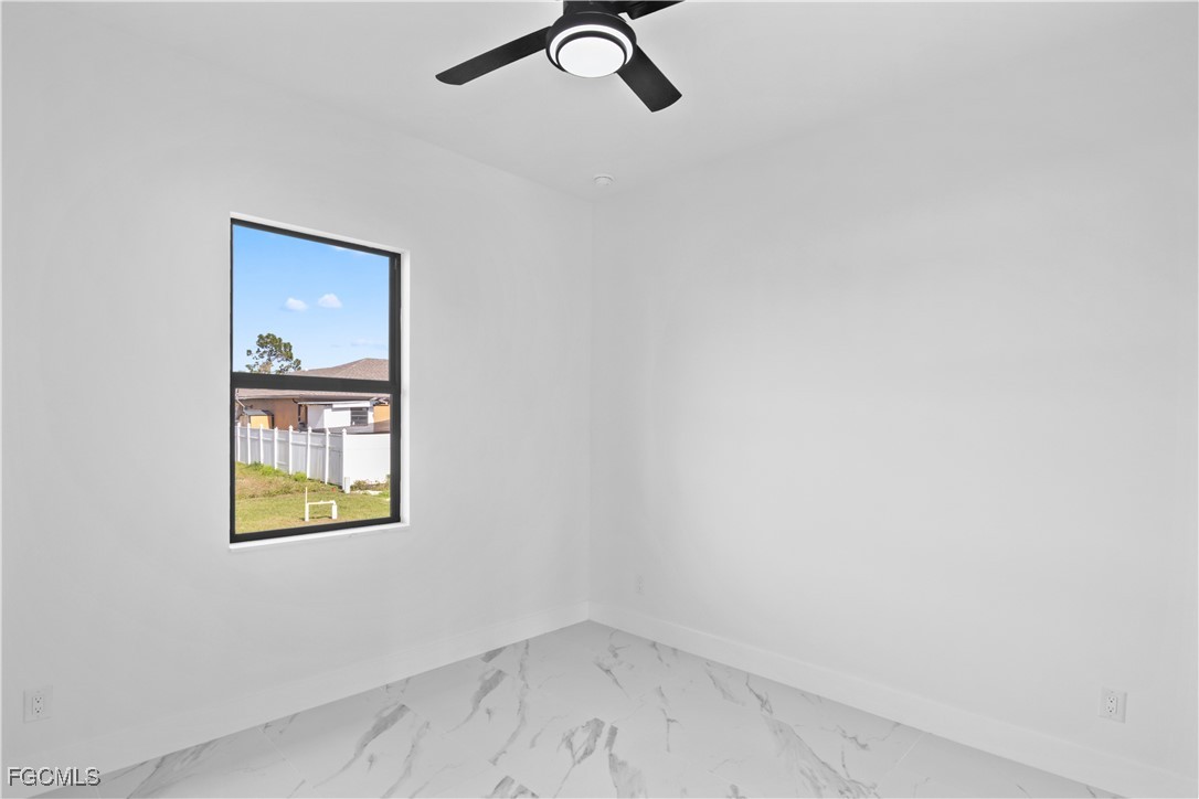 4006 5th Street Southwest Lehigh Acres, FL 33976 - Photo 28 of 32 an empty room with a window and a ceiling fan