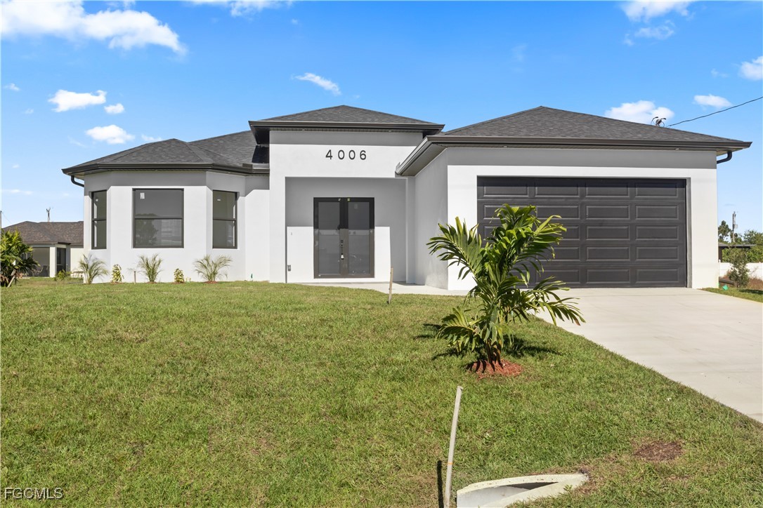 4006 5th Street Southwest Lehigh Acres, FL 33976 - Photo 6 of 32 a front view of a house with a yard