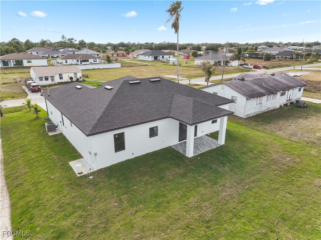4006 5th Street Southwest Lehigh Acres, FL 33976 - Photo 9 of 32 an aerial view of a house with a swimming pool and outdoor space