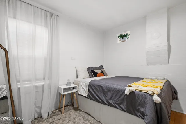 a bedroom with a bed and a window