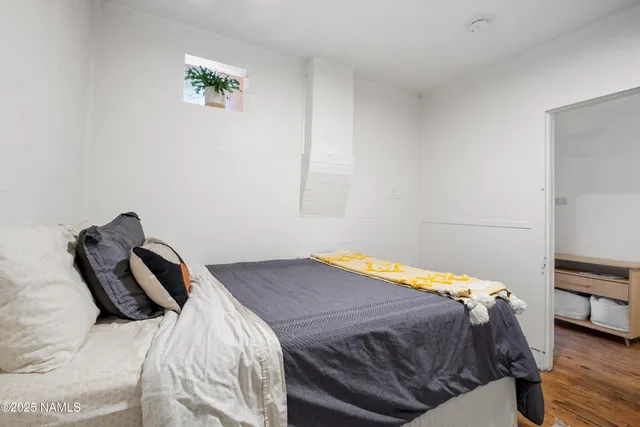 a bedroom with a bed and a couch