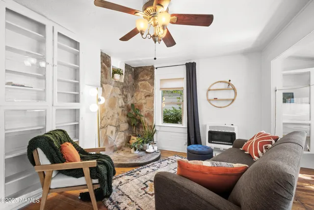 a living room with furniture a chandelier and a large window