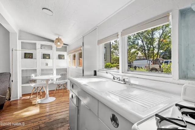 a dining hall with stainless steel appliances granite countertop a stove and a sink