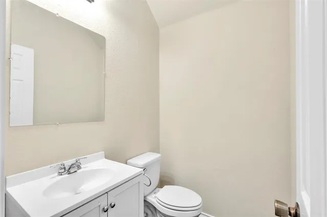 a bathroom with a sink a toilet and mirror