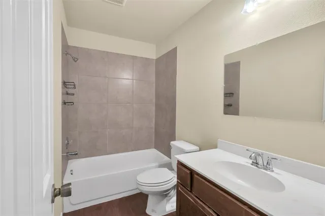 a bathroom with a sink a toilet and a bathtub