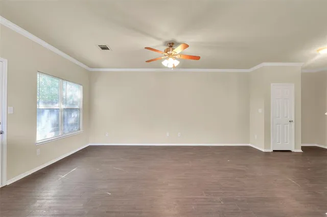 an empty room with windows and air conditioner