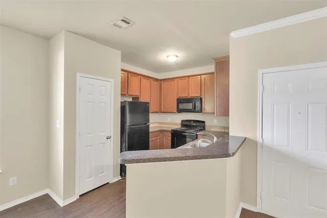 a kitchen with stainless steel appliances granite countertop a refrigerator stove top oven a sink and dishwasher