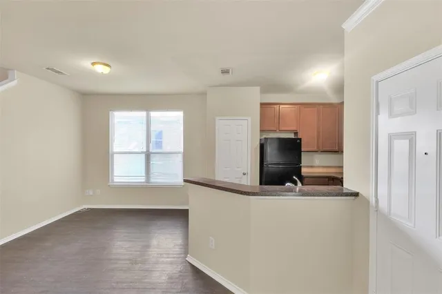 a view of a kitchen with a sink and a refrigerator