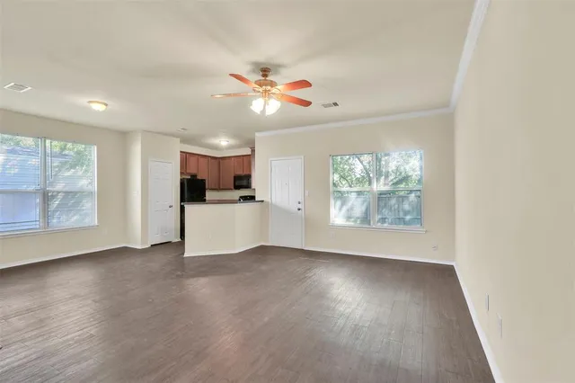 a view of a kitchen with wooden floor and window