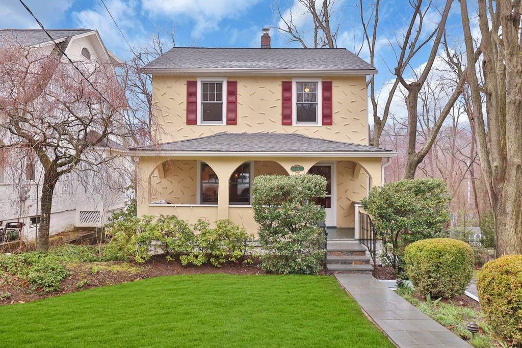 a front view of a house with a yard