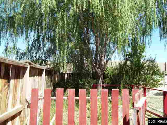 391 B Bens Way Fernley, NV 89408 - Photo 8 of 10 a view of a white house with wooden fence