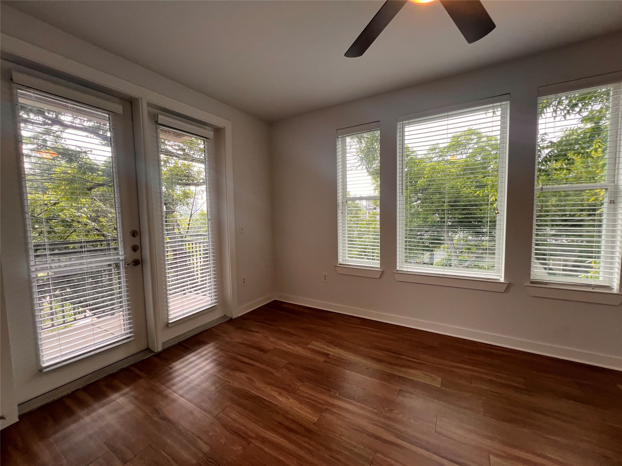 1900 Barton Springs Road, Unit 4041 Austin, TX 78704 - Photo 5 of 35 a view of an empty room with wooden floor and a window