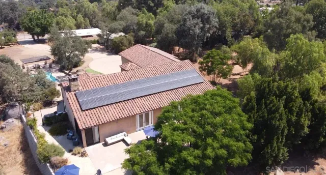 a kitchen with stainless steel appliances kitchen island granite countertop a table chairs sink and cabinets