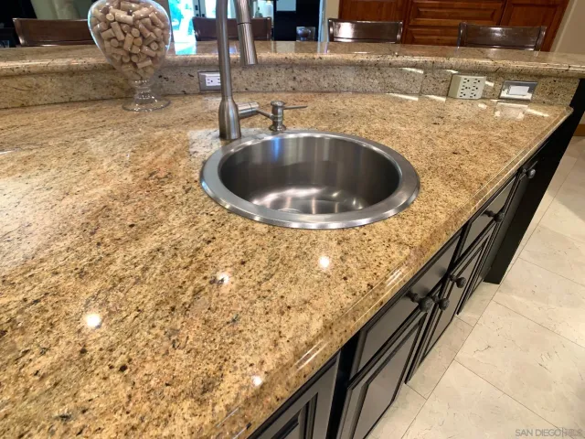 a bathroom with a sink a toilet a mirror and shower